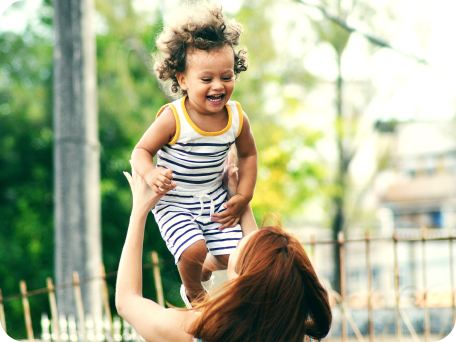 Woman playing with her daughter and throwing her into the air